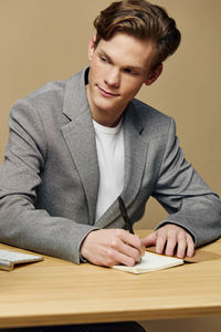 Portrait of young man working at table