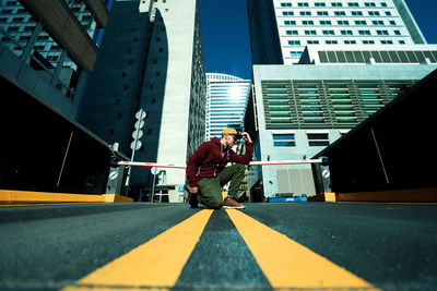Low angle view of man standing in city