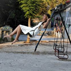 Beautiful woman swinging at playground