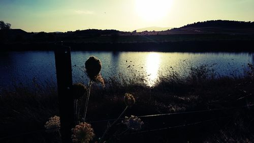 Scenic view of lake against sky during sunset