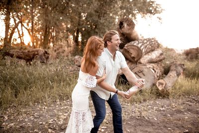 Full length of woman standing on field against trees