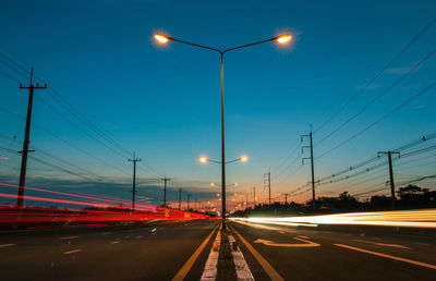 Cars on road against sky at night