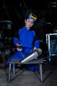 Portrait of young woman standing in cafe