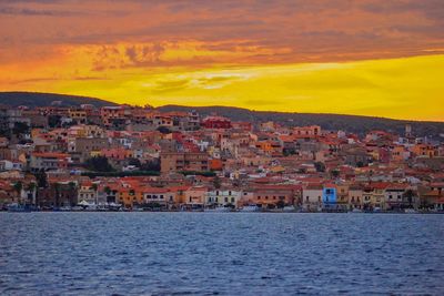 Buildings in city at sunset