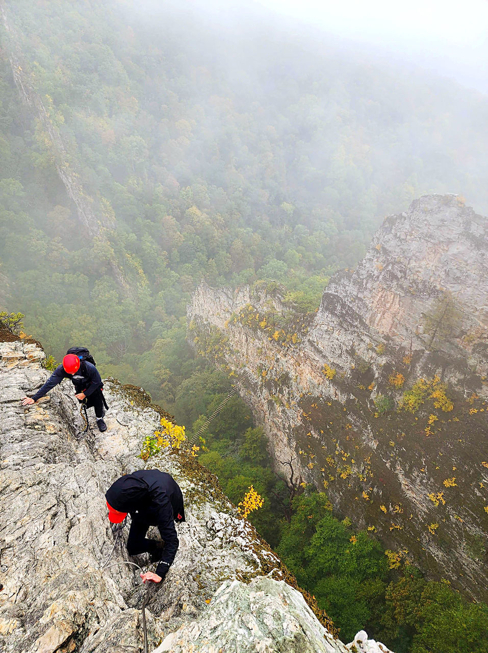 mountain, activity, adventure, leisure activity, rock, nature, climbing, extreme sports, sports, hiking, ridge, scenics - nature, beauty in nature, high angle view, fog, environment, adult, men, landscape, land, travel, mountain climbing, mountaineering, day, lifestyles, full length, mountain range, outdoors, recreation, walking, rock climbing, backpack, one person, travel destinations, risk, non-urban scene, holiday, vacation, trip, rear view, challenge, plant, communication, exploration, person, courage, determination, tranquil scene, tourism, sign, rock formation, motion, warning sign