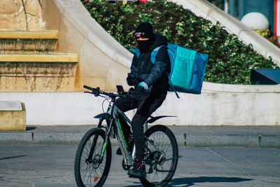 Side view of man riding bicycle