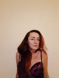 Young woman standing against white background