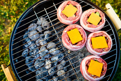 High angle view of meat on barbecue grill