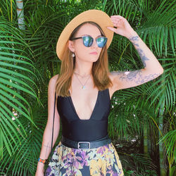 Young woman wearing sunglasses on field