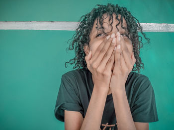 Portrait of a person hiding face covered with hand