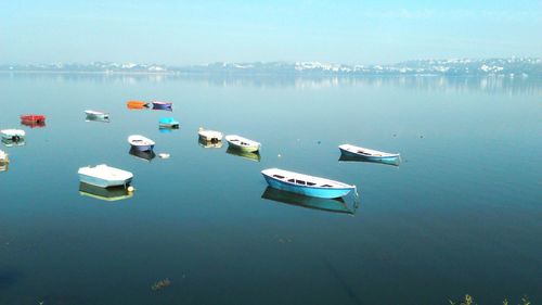 High angle view of boats moored at lake against sky