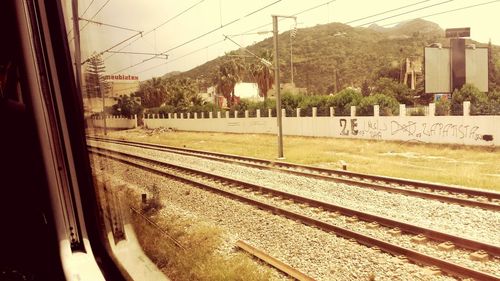 Railroad tracks seen through train window