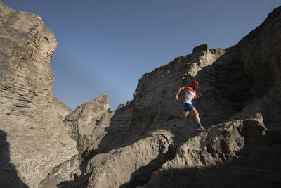 One man trail running on a sandy terrain made of old mining sand