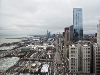 Aerial view of buildings in city against sky