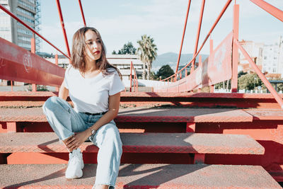 Portrait of young woman sitting on staircase