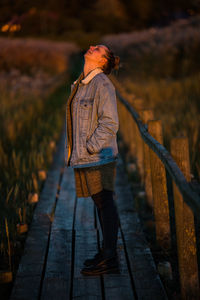 Rear view of woman walking on a dock