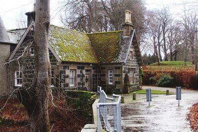 View of built structure with bare trees in foreground