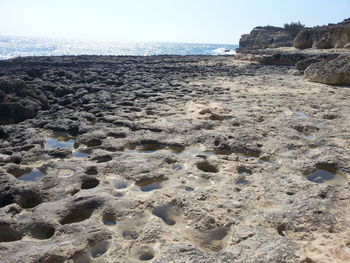 Surface level of beach against clear sky