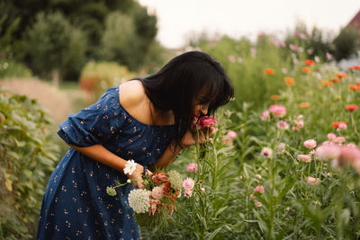 A young woman prune flowers in a floristic flower farm. woman florist.