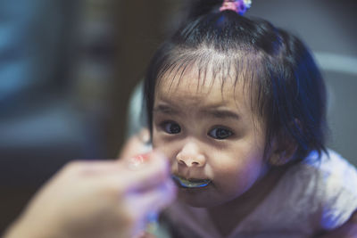 Close-up portrait of cute girl having food