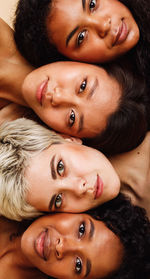 Directly above portrait of women lying side by side