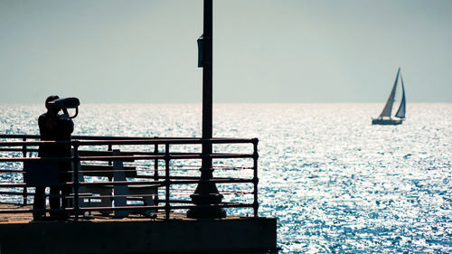Sailboat on sea against clear sky