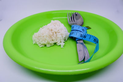 Close-up of green slices in bowl on table