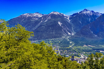 Scenic view of snowcapped mountains against clear blue sky