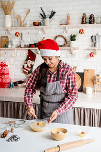 Midsection of woman holding food at home