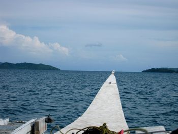 Sailboat in sea against sky