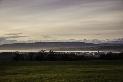 Scenic view of landscape against sky at sunset