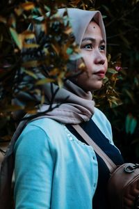 Portrait of young woman looking away