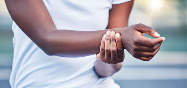 Midsection of woman holding hands