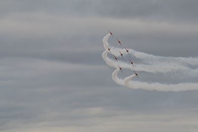 Low angle view of airplane flying against sky