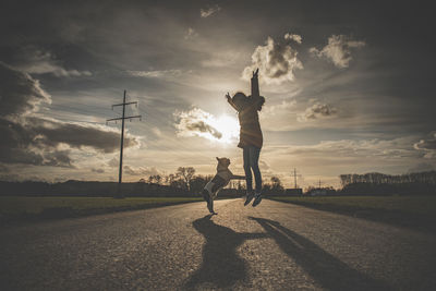 Man playing soccer on field against sky during sunset