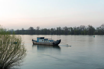 Boat moored on river against sky