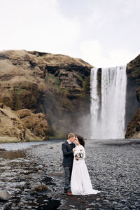 Rear view of couple kissing in water