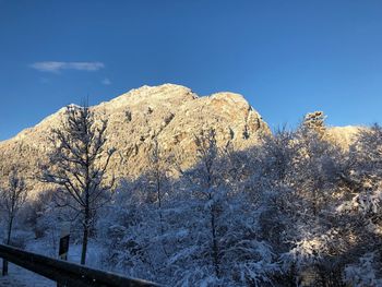 Scenic view of snowcapped mountains against clear blue sky