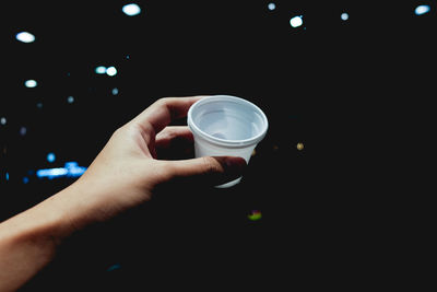 Close-up of hand holding coffee cup