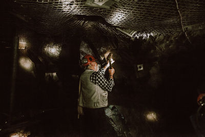 Man working in gold mine cave