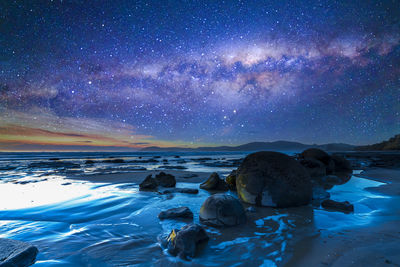 Scenic view of sea against sky at night