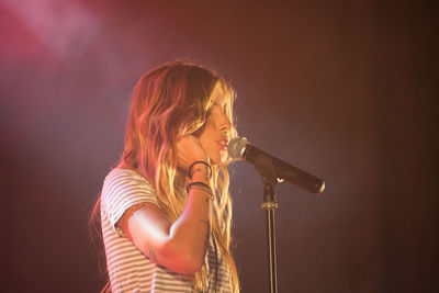 Midsection of woman playing at music concert