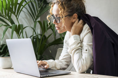 Young woman using laptop at table