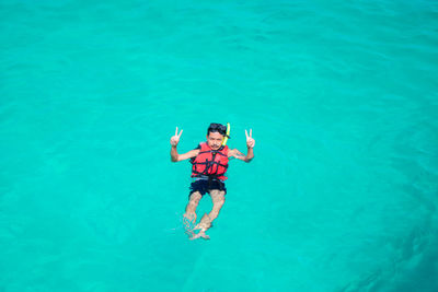 High angle view of man swimming in sea