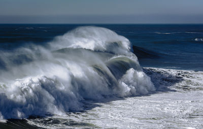 Big wave breaking at praia do norte, nazare