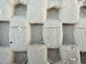 Beach sand shaped like a stone wall