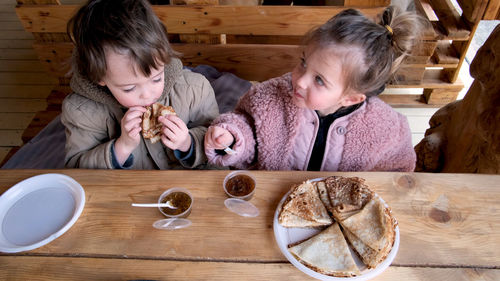 Cute girl and food on table