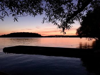 Scenic view of lake against orange sky