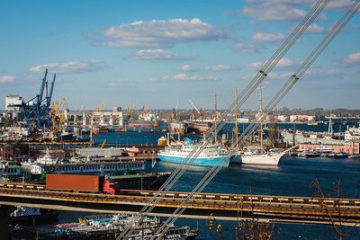 High angle view of ships moored at harbor against sky