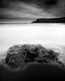 View of calm sea against cloudy sky